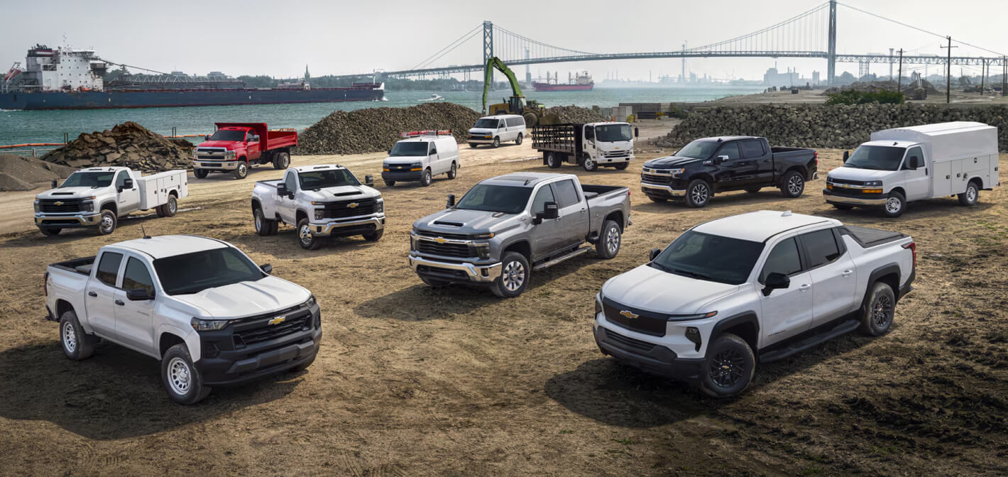 An aerial view of the 2026 Chevy HD lineup on a work site including several Silverado HD models all in Summit white.