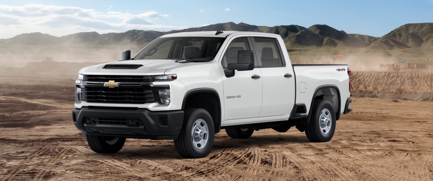 Silverado 2500 HD WSide view of the 2026 Silverado 2500 HD WT in Summit White on a sandy desert road.