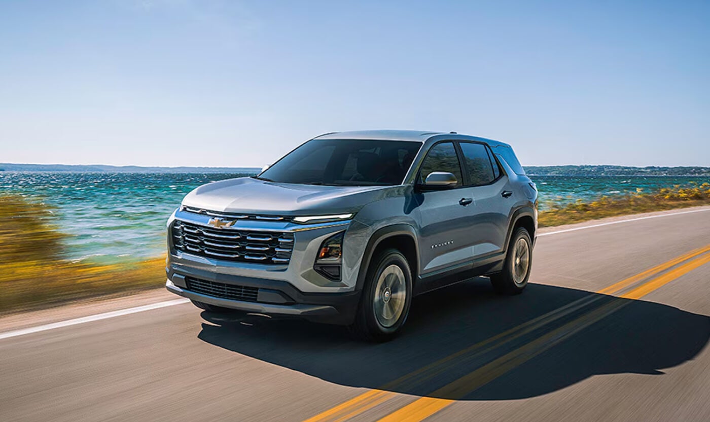 2026 Chevy Equinox EV in Silver Driving Down the Highway