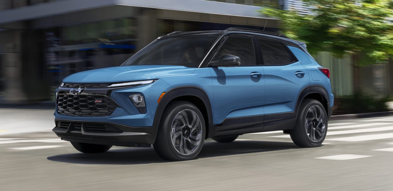 Blue Chevrolet Trailblazer RS driving through a city street.
