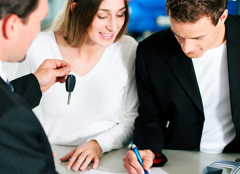 Customers signing forms | Bomnin Chevrolet Dadeland in Miami FL